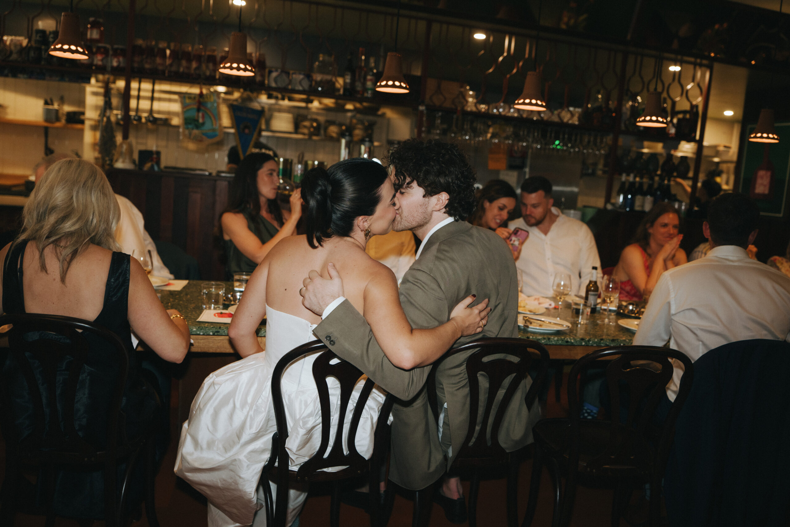 Bride and groom Alana and Peter share a kiss at their intimate wedding reception lunch at Bastardo Surry Hills